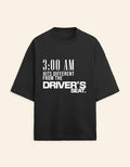 Black t-shirt with white text on a beige background