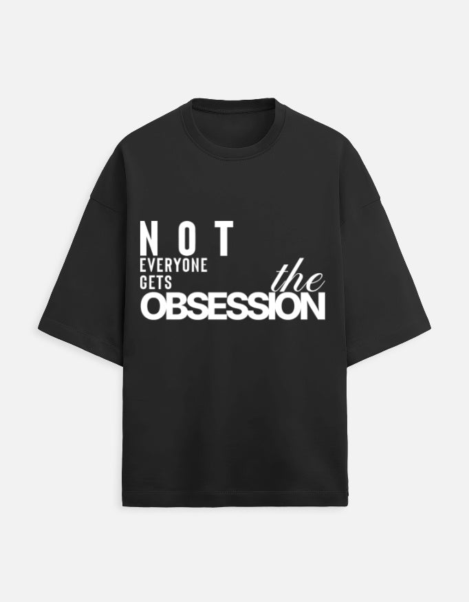 Black t-shirt with white text 'Not everyone gets the obsession' on a white background